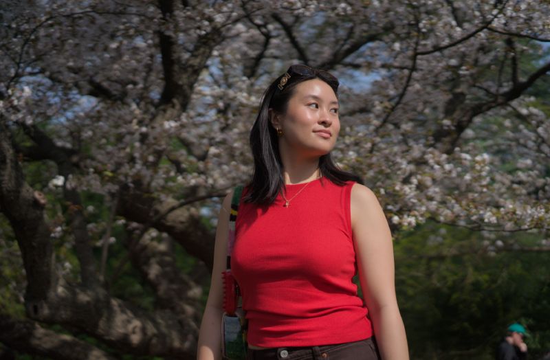 Abby standing in cherry blossoms.